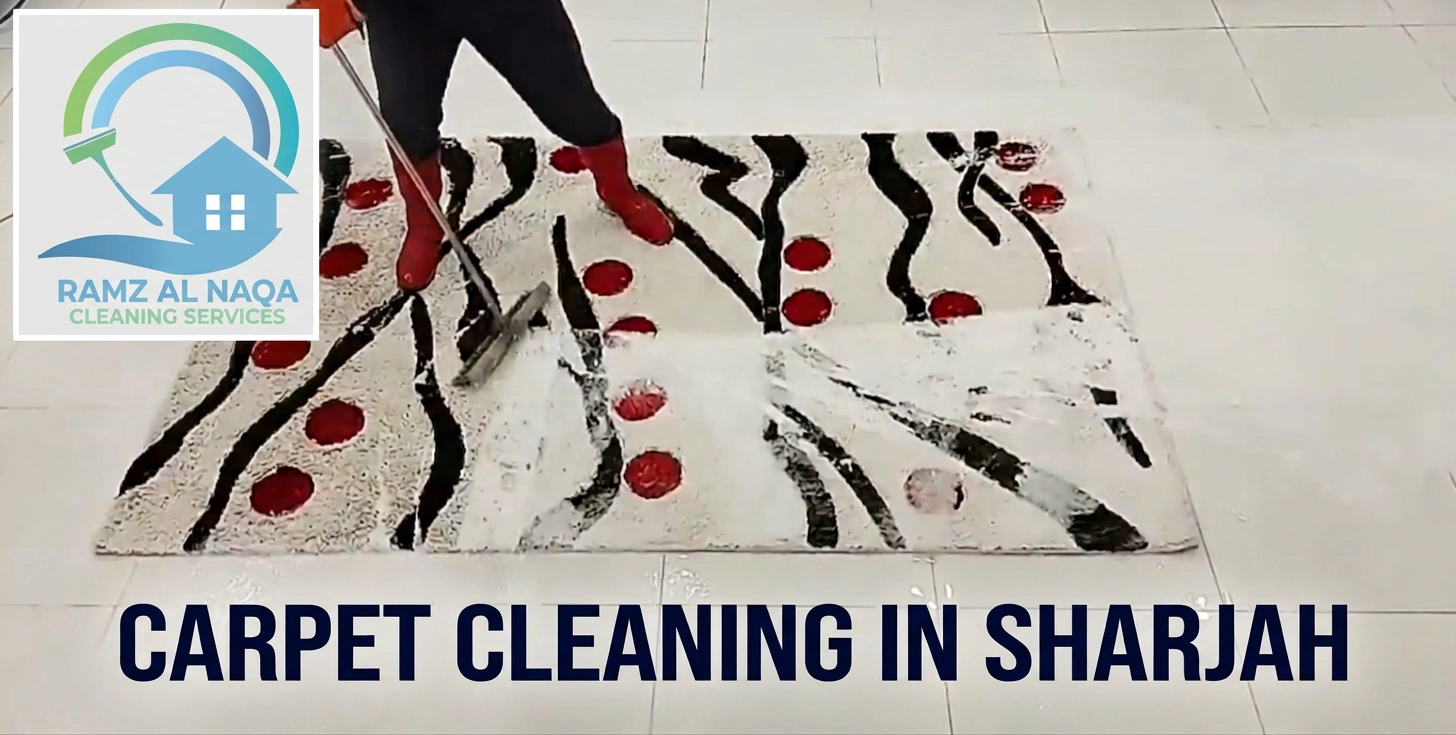 Carpet cleaning in Sharjah with professional extracting foam from patterned rug, Ramz Al Naqa Cleaning Services logo visible.